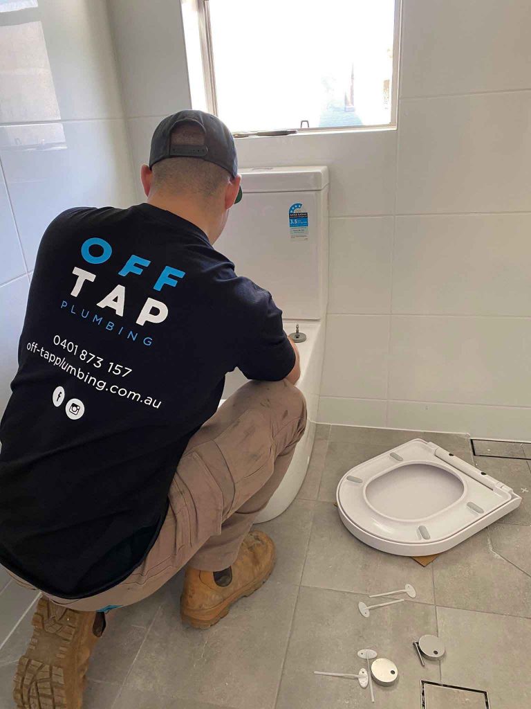 Jesse Sorensen fixing toilet